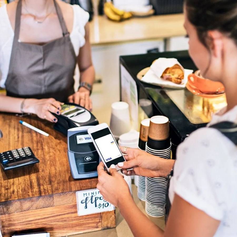 woman paying with mobile in store