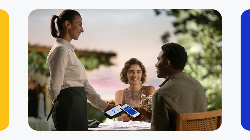 couple paying by phone at restaurant